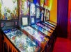 A row of bright and colorful pinball and other game machines at the Gatlinburg Space Needle.