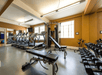 Fitness facility with treadmills, free weights, and bench press.