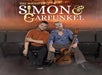 Two men sitting on theater seats, one with an acoustic guitar. The text above reads "The Sound of Simon & Garfunkel.