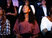 A woman sitting in the audience in awe of the special effects and multi-sensory film at the The Sphere Experience.