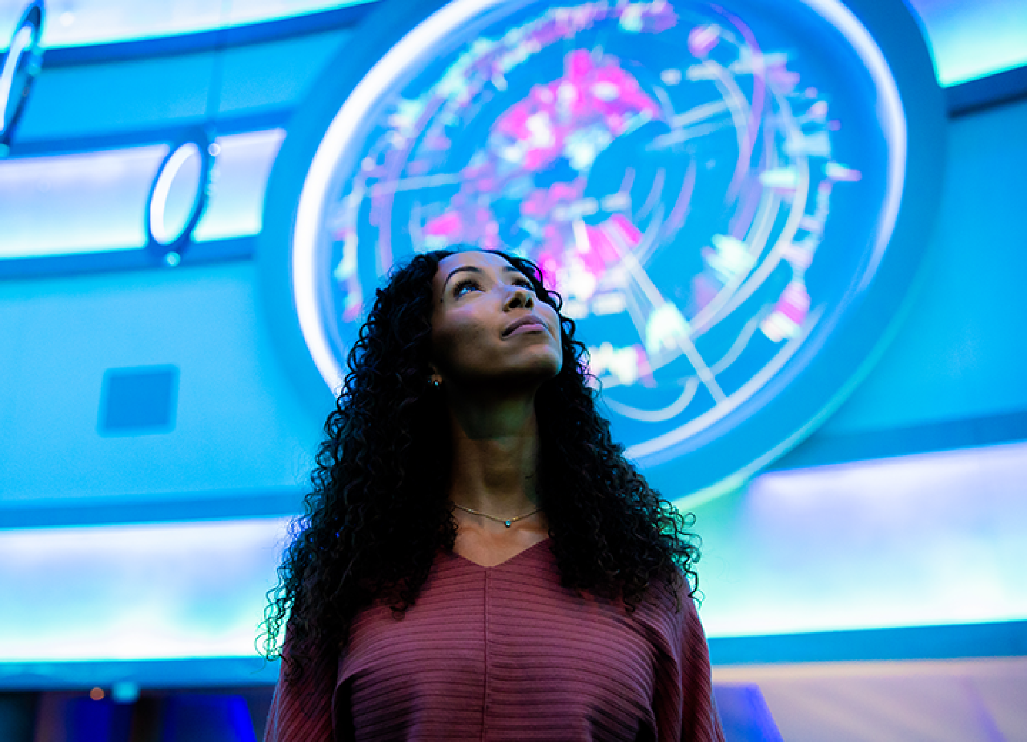 A woman is immersed in an atrium filled with 22nd century technology  at The Sphere, Las Vegas, Nevada.