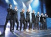 Men in black suits singing