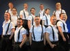 Irish dancers wearing white shirts with black suspenders