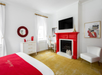 Guest room with a king bed, workstation, and a fireplace