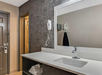 A private bathroom with sink, large mirror and fresh towels.