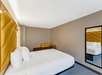 One King bed and a seating area inside a guest room.