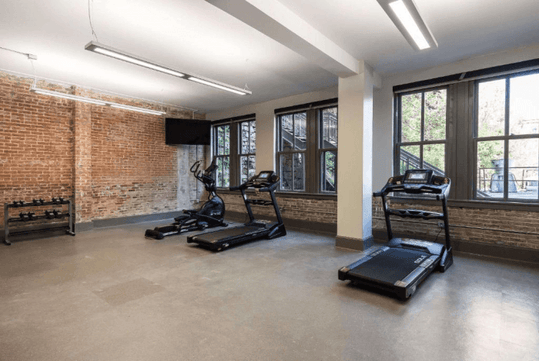 Fitness facilities with cardio equipment and weights.