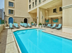 Outdoor pool with sun loungers.