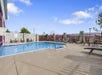 A outdoor pool area with chairs lining the sides at Thousand Hills Resort Hotel on bright sunny day.