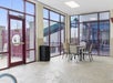 A table in the corner of the indoor pool area with windows showing the outdoor pool area at Thousand Hills Resort Hotel.