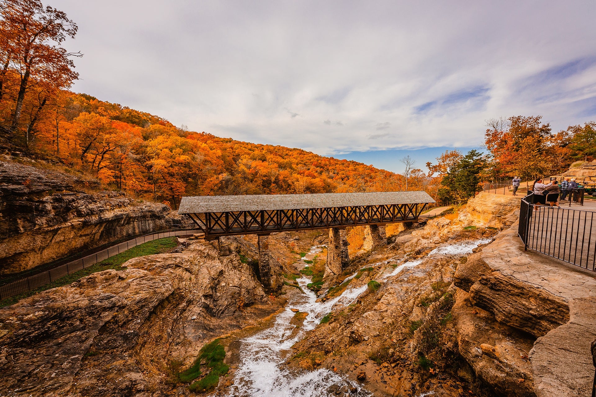 View of the Ozark Mountains and Amish Bridge with waterfalls below.