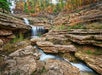 Cascading waterfalls in the fall at Top of the Rock Lost Canyon Nature Trail.