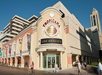 Exterior view of the Tropicana Atlantic City casino entrance with people walking and biking nearby.