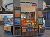 Convenience store interior with shelves stocked with snacks, drinks, and local items. Signs display "eat & sip" and "local items." Modern design with circular ceiling feature.