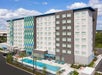 Aerial view of the back of the Tru by Hilton Orlando Convention Center Area with a long bright blue swimming pool on a sunny day.