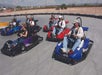 Family-friendly outdoor fun racing go-karts on the track.