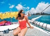A woman soaking up the sun on the catamaran in Waikiki, Hawaii.