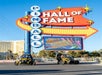 Two GoCars with tourists in them parked in front of the sign for the Pinball Hall of Fame on a sunny day in Las Vegas.