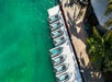 A fleet of jet skis lined up at the dock.