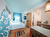 Two Queen beds and a flat-screen TV inside a guest room.