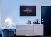 Room features a TV, work desk, and coffee machine.