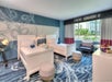 2 Beds and a seating area inside a guest room.