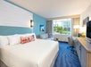 1 King bed and a seating area inside a guest room.