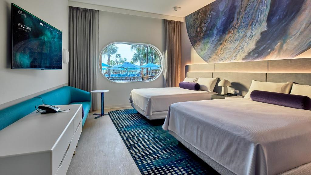 Guest room with two queen beds, and a seating area