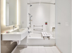 Accessible bathroom with a bath tub and shower