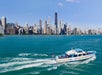 A view of the boat going across the lake with Chicago in the background on the Urban Adventure Cruise in Chicago, Illinois, USA.