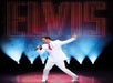 A man in a white suit with a bright red tie singing into a microphone with his other arm out at VEGAS! THE SHOW.