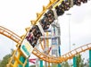 A roller coaster car full of people going upside down on the Corkscrew coster at Valleyfair in Bloomington, Minnesota.