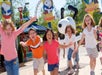Children running in front of a statue of Snoopy at Valleyfair in Bloomington, Minnesota.