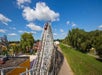 Wide shot of a coaster car going downhill on the Renegade coaster on a sunny day at Valleyfair in Bloomington, Minnesota.