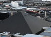 A helicopter flies above the Luxor Hotel’s pyramid-shaped building in Las Vegas, with city buildings visible in the background.