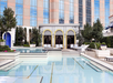 Outdoor pool with sun loungers.