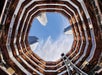 View from the base of Vessel looking up through its geometric structure to the sky.