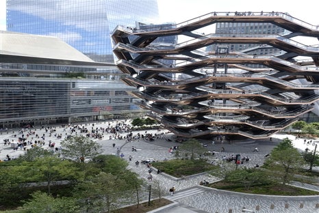 A wide view of Vessel NYC and the surrounding plaza filled with visitors.