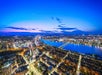 View of the city of Boston full of lights at night from the View Boston Observatory.