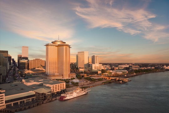 An aerial shot of the Four Seasons hotel and the Vue Orleans Observation deck at sunset.