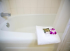 Bathroom with bathtub and fresh towels.