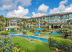 Scenic resort exterior with outdoor pool.