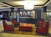 Hotel lobby with the front desk and area seating for four.