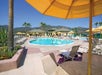 Outdoor pool with sun loungers with views of the mountains.