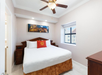 Queen bed inside one of the bedrooms with premium bedding.