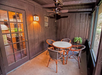 A screened-in balcony/patio.