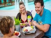 A family sitting at a picnic table having lunch at White Water in Branson, Missouri.