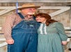 An older man and woman in costumes posing together for a photo at WhoDunnit Hoedown Murder Mystery Dinner Show in Branson, Missouri.