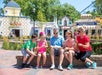 A family sitting and having a snack at Worlds of Fun amusement park in Kansas City, Missouri.