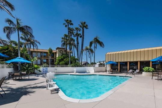 Refreshing outdoor pool with seating area and pool lift.